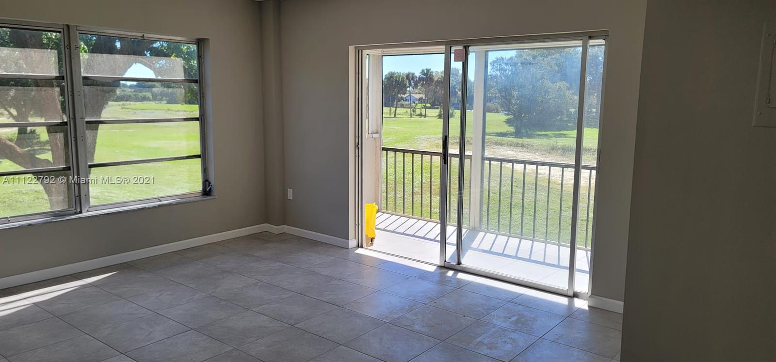 a view of empty room with floor to ceiling window