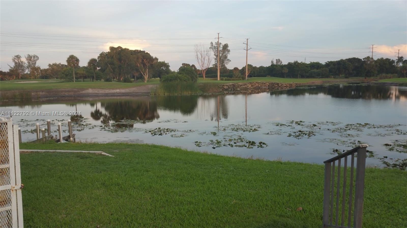 Manors of Inverrary Condominiums Lauderhill, FL 33319 - Photo 16 of 17 a view of a lake with houses in the back