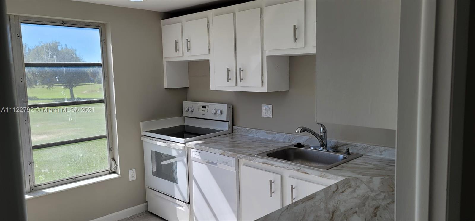 Manors of Inverrary Condominiums Lauderhill, FL 33319 - Photo 3 of 17 a kitchen with white cabinets and sink