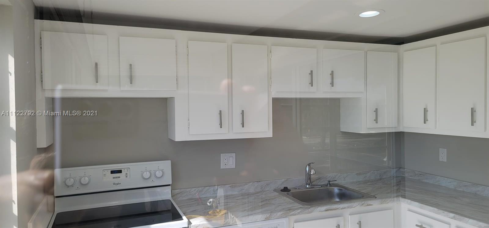 Manors of Inverrary Condominiums Lauderhill, FL 33319 - Photo 4 of 17 a room with cabinets and a window