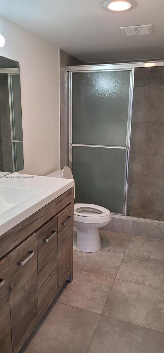 Manors of Inverrary Condominiums Lauderhill, FL 33319 - Photo 9 of 17 a bathroom with a granite countertop sink a toilet a mirror and shower