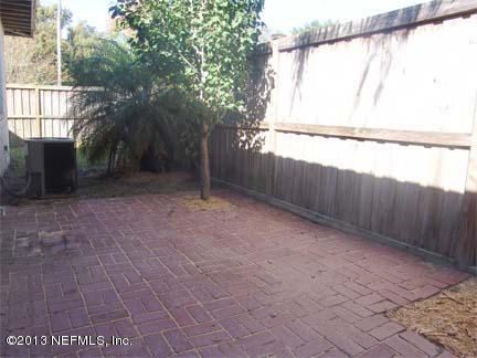 1911 Clemson Road Jacksonville, FL 32217 - Photo 8 of 26 a view of a backyard with large trees and wooden fence