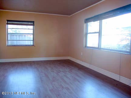 1911 Clemson Road Jacksonville, FL 32217 - Photo 9 of 26 an empty room with wooden floor and windows