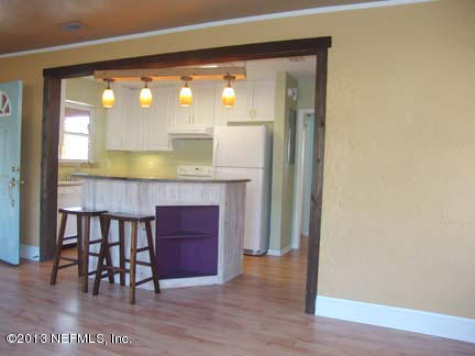 1911 Clemson Road Jacksonville, FL 32217 - Photo 10 of 26 a kitchen with granite countertop a stove and a wooden floor