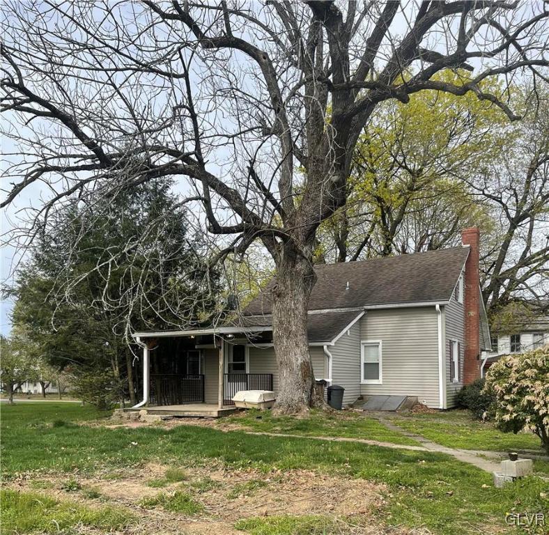 556 Jacobsburg Road Nazareth, PA 18064 - Photo 18 of 18 a front view of a house with a garden and trees