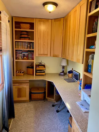 a room with a workspace and a window