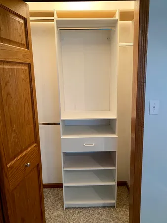 a view of walk in closet with empty racks