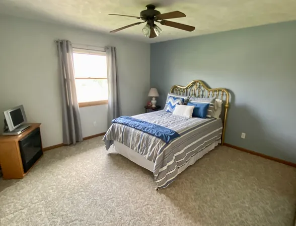 a bedroom with a bed and a chandelier