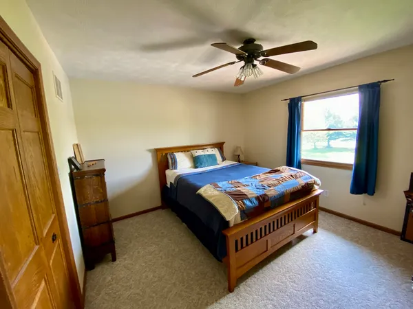 a bedroom with a bed and window