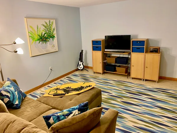 a living room with a flat screen tv and a couch