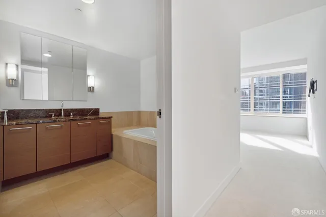 a bathroom with a tub a sink and a shower