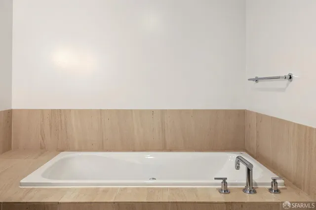 a bathroom with a granite countertop sink a toilet and shower