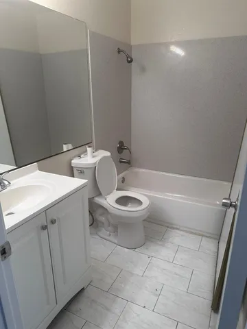 a white toilet sitting next to a bathroom sink