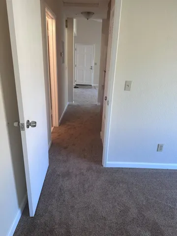 an entryway door with a hallway in the house