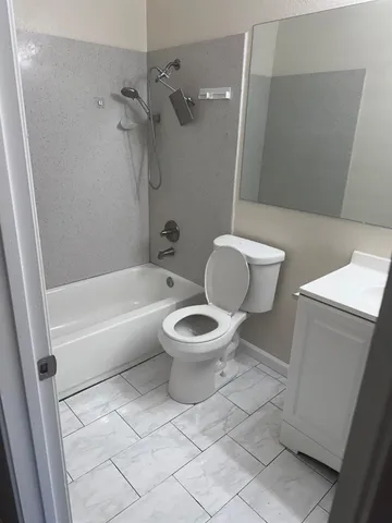 a bathroom with a toilet and a bathtub