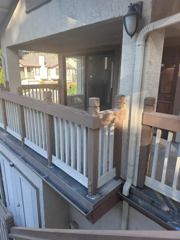 a view of staircase with railing and a rug