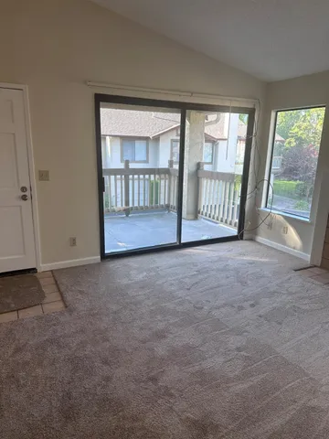 a view of an empty room with a balcony