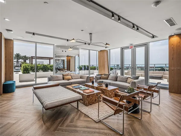 a living room with furniture large window and flat screen tv