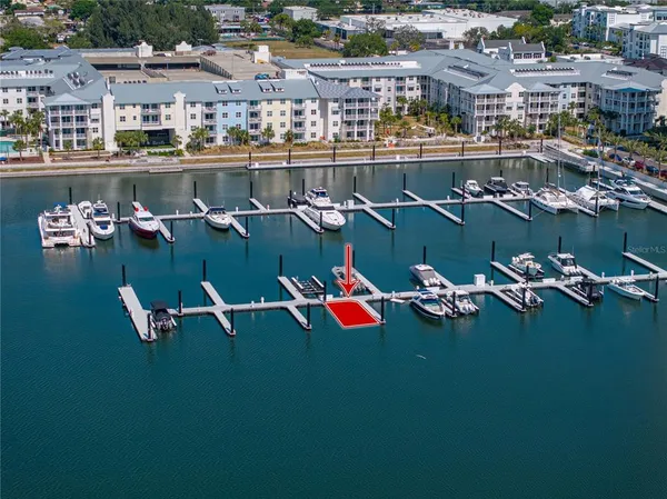 an aerial view of residential houses with outdoor space and lake view