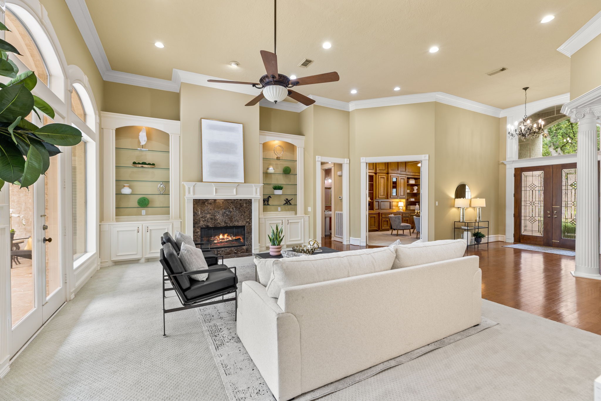 6610 Radley Drive Spring, TX 77379 - Photo 9 of 50 The 20' ceilings and open concept create a grand atmosphere. Glass lite bookshelves flanking the marble fireplace to showcase your prized possessions. Great view into study/office.
