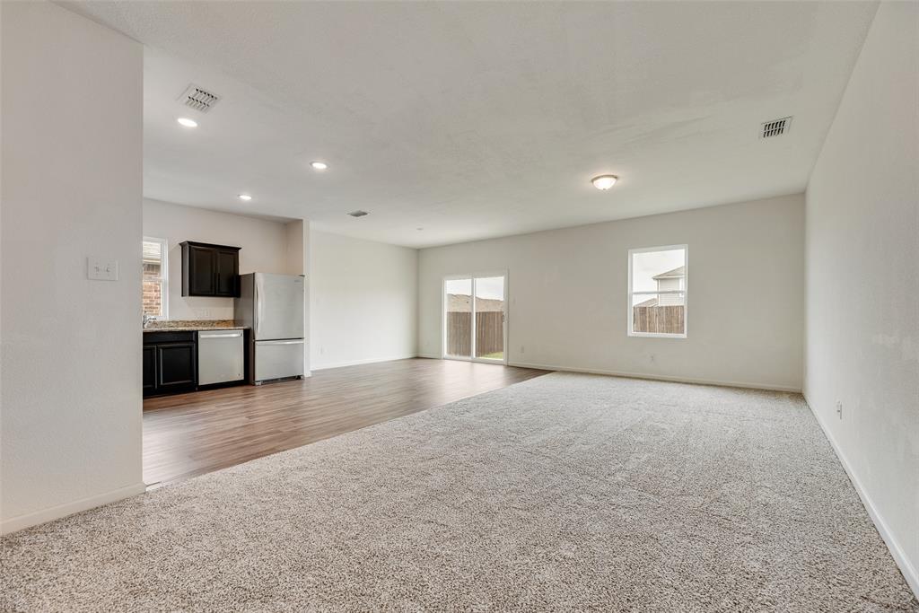 708 Peach Tree Lane Anna, TX 75409 - Photo 11 of 32 an empty room with windows and fireplace