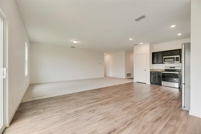 a view of kitchen with microwave and cabinets
