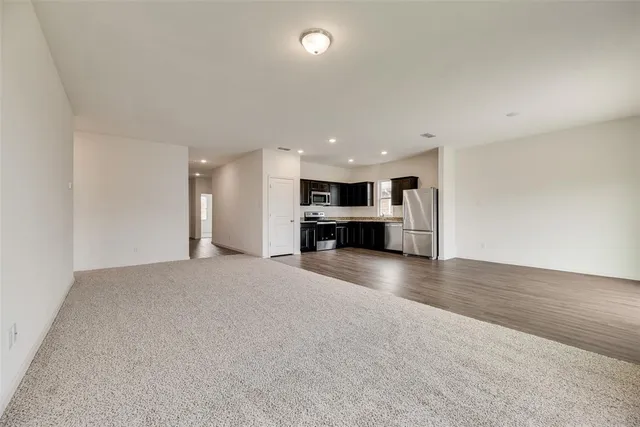 a view of kitchen with a sink and a refrigerator