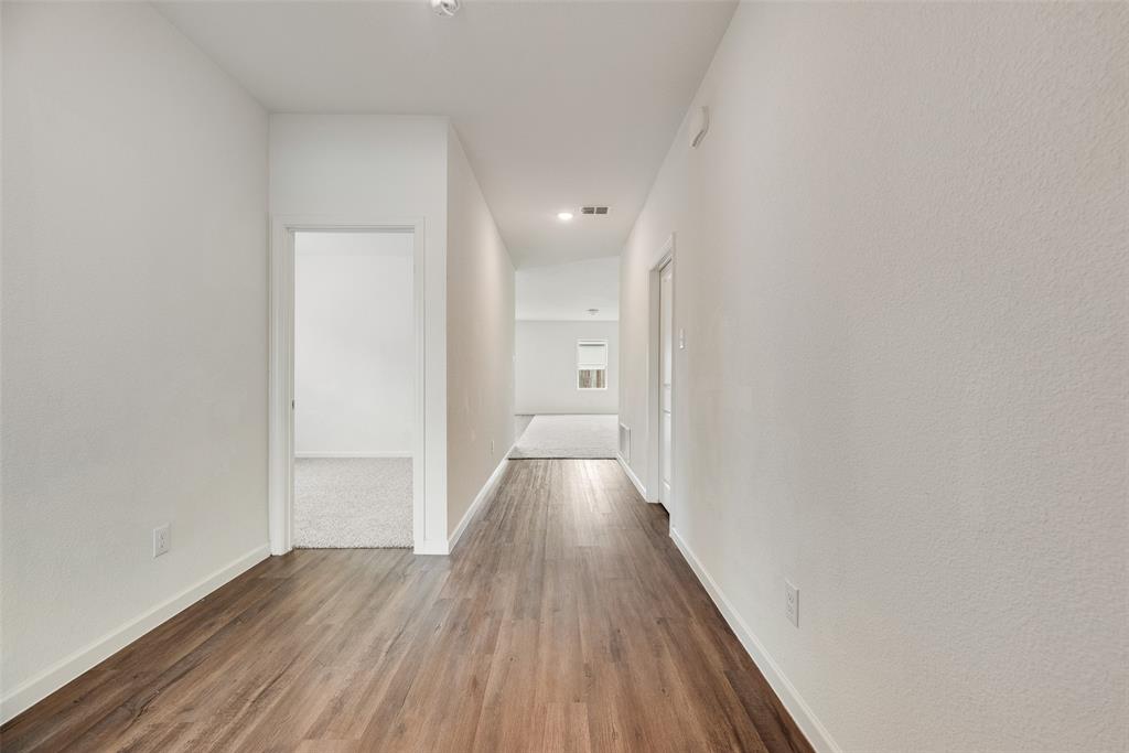 708 Peach Tree Lane Anna, TX 75409 - Photo 17 of 32 a view of hallway with wooden floor