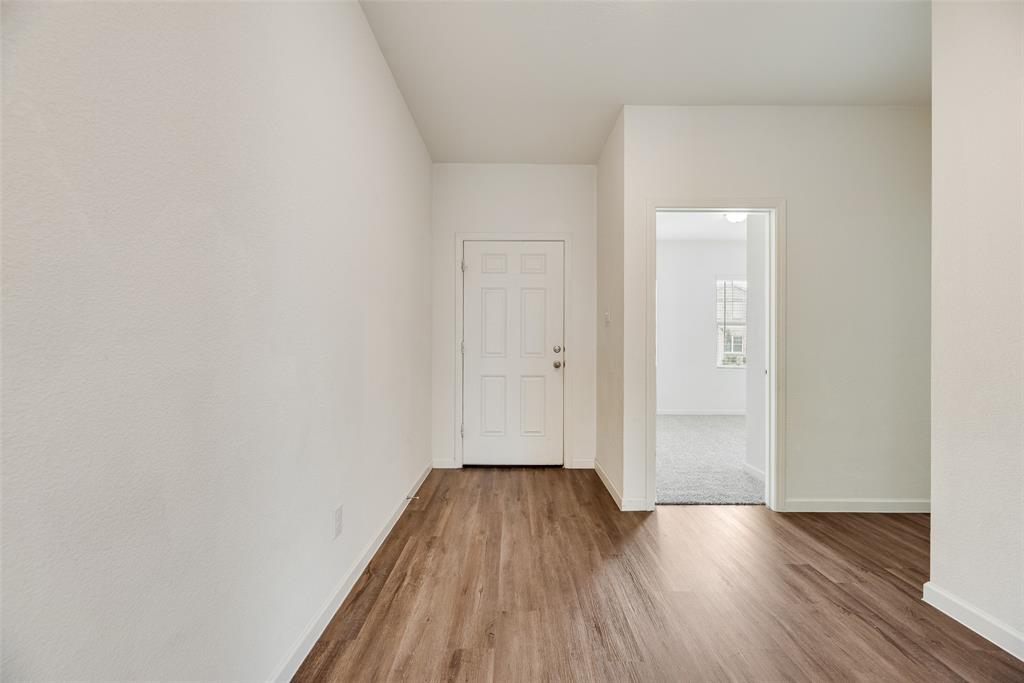 708 Peach Tree Lane Anna, TX 75409 - Photo 2 of 32 a view of a room with wooden floor and bench