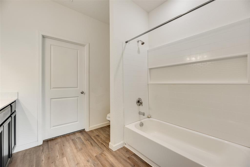 708 Peach Tree Lane Anna, TX 75409 - Photo 24 of 32 a bathroom with a tub shower and a sink