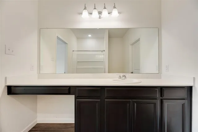 a sink with a mirror and vanity