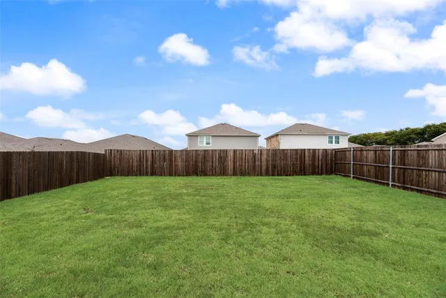 a view of a backyard with table and chairs