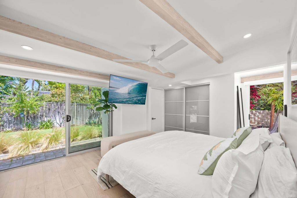 612 8th Street Del Mar, CA 92014 - Photo 5 of 12 a bedroom with a large bed and a large window