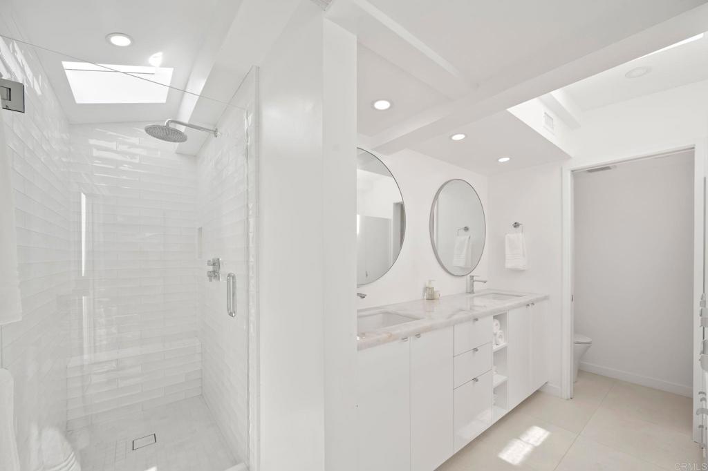 612 8th Street Del Mar, CA 92014 - Photo 6 of 12 a bathroom with a shower sink mirror and toilet