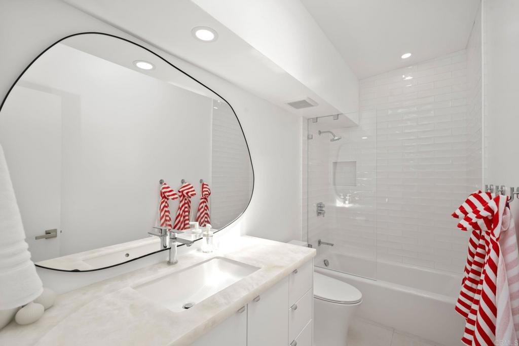 612 8th Street Del Mar, CA 92014 - Photo 9 of 12 a bathroom with a sink and mirror with toilet