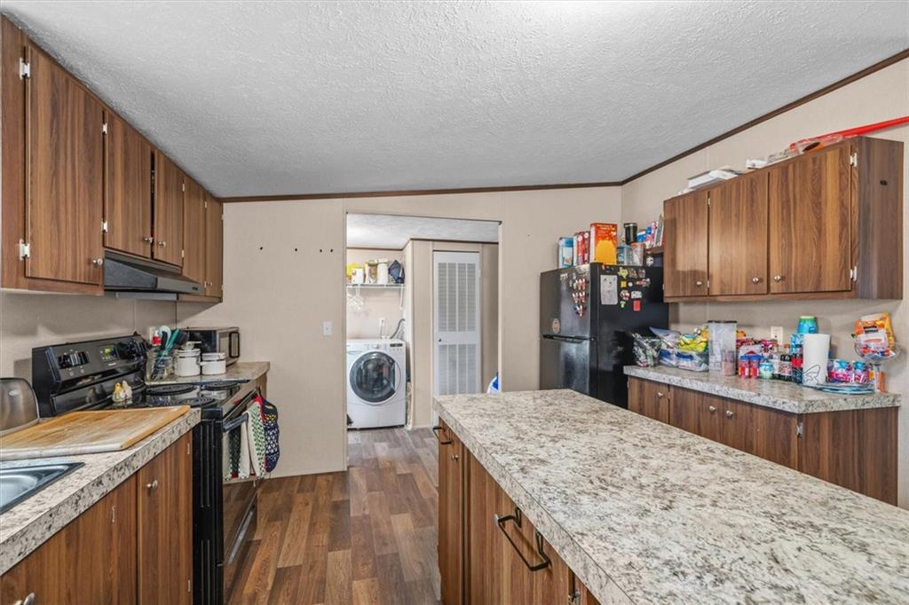 1185 Shirley Road Southeast Fairmount, GA 30139 - Photo 12 of 50 a kitchen with stainless steel appliances granite countertop a refrigerator stove top oven and sink