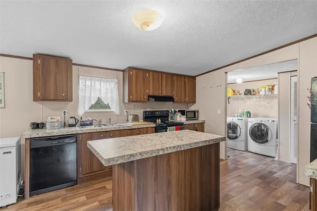a kitchen with a sink a stove and cabinets