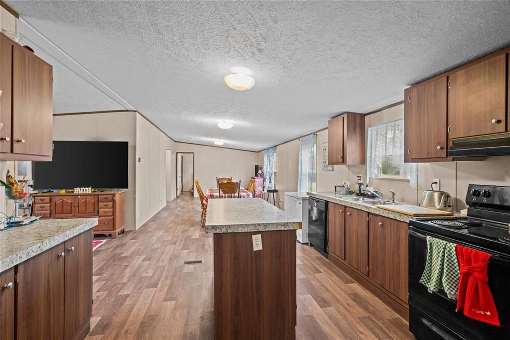 1185 Shirley Road Southeast Fairmount, GA 30139 - Photo 14 of 50 a large kitchen with stainless steel appliances granite countertop a stove refrigerator and a sink