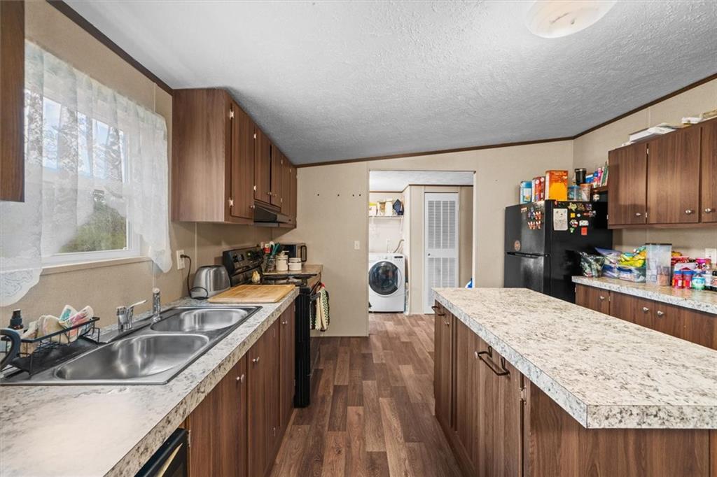1185 Shirley Road Southeast Fairmount, GA 30139 - Photo 15 of 50 a kitchen with a sink stove and refrigerator