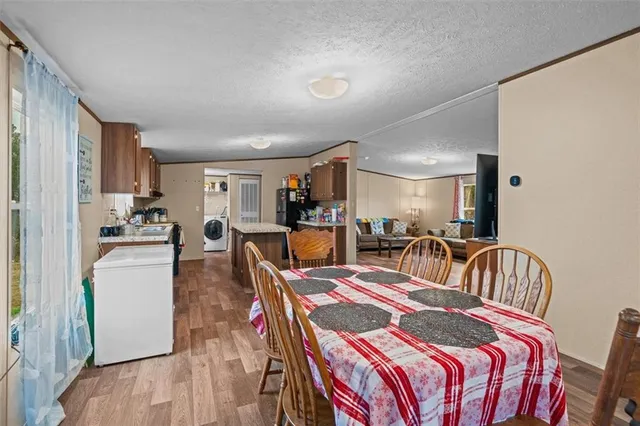 a very nice looking living room with a dining table and chairs