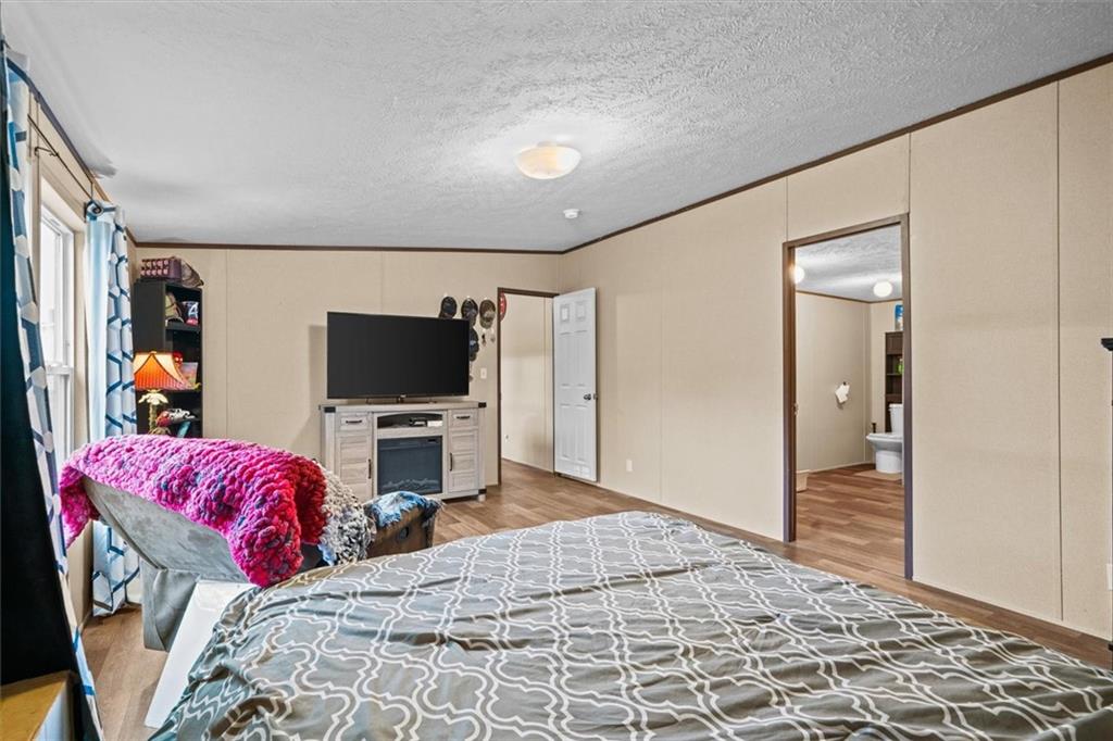 1185 Shirley Road Southeast Fairmount, GA 30139 - Photo 23 of 50 a bedroom with a bed and a flat screen tv