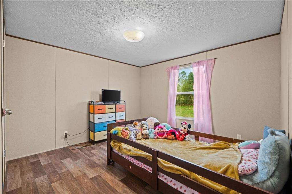 1185 Shirley Road Southeast Fairmount, GA 30139 - Photo 27 of 50 a bed room with a bed and a window