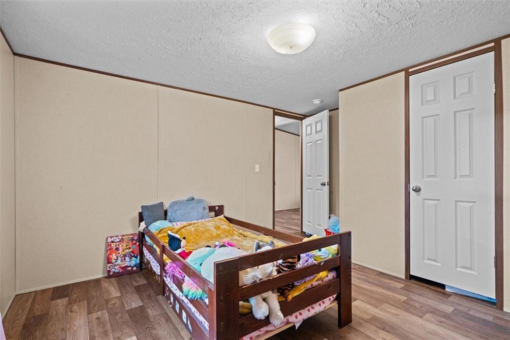 1185 Shirley Road Southeast Fairmount, GA 30139 - Photo 28 of 50 a room with a bed and wooden floor