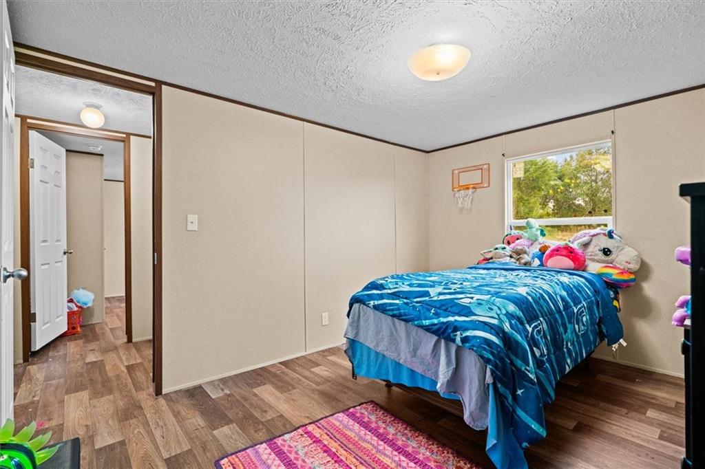 1185 Shirley Road Southeast Fairmount, GA 30139 - Photo 30 of 50 a bedroom with a bed and a dresser next to a window