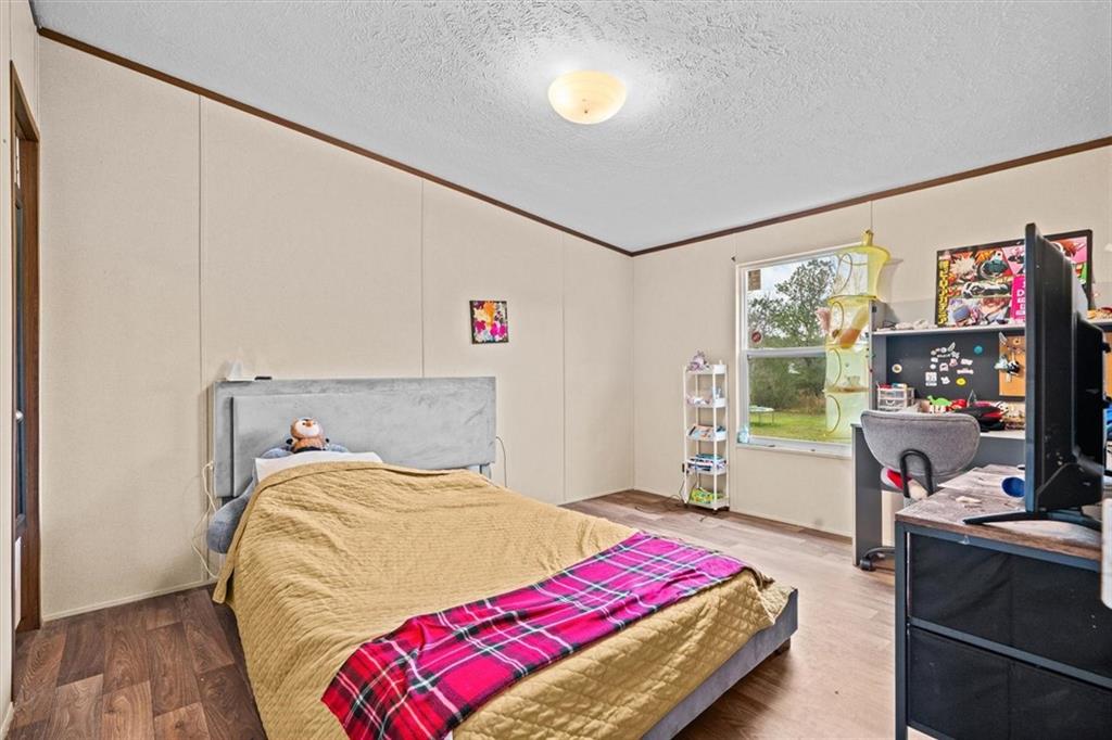 1185 Shirley Road Southeast Fairmount, GA 30139 - Photo 32 of 50 a bedroom with a bed and a flat tv screen on dresser