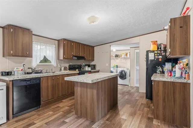 a kitchen with cabinets and wooden floor