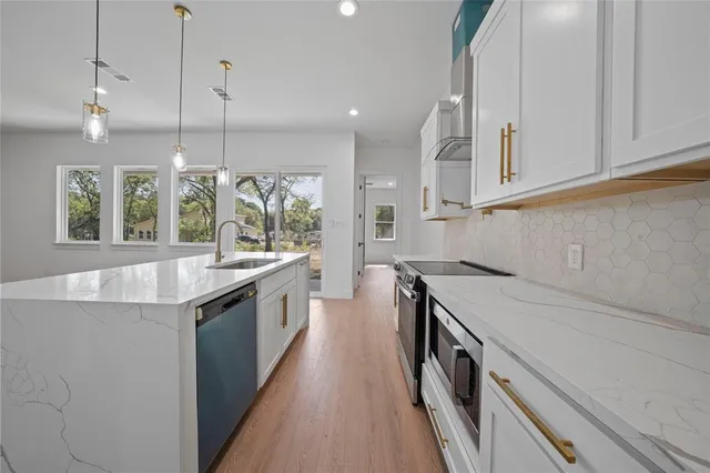 a kitchen with a sink and stove