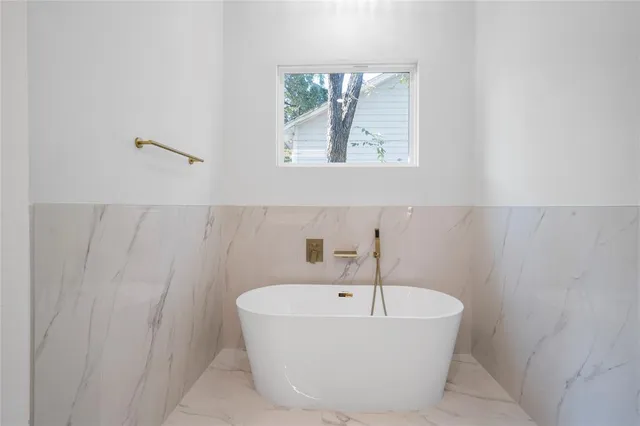 a bathroom with a bathtub and window