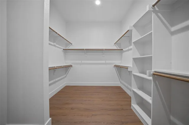 a view of a room with wooden floors and lots of racks