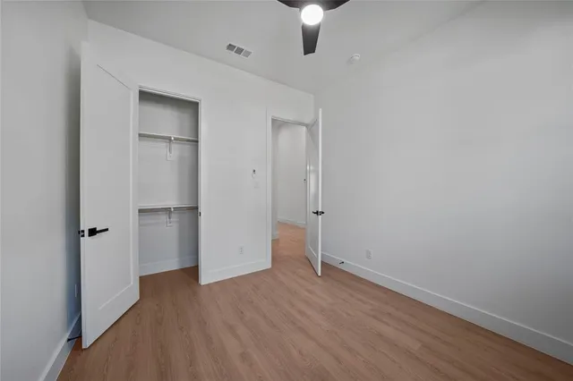 an empty room with a hardwood and wooden door